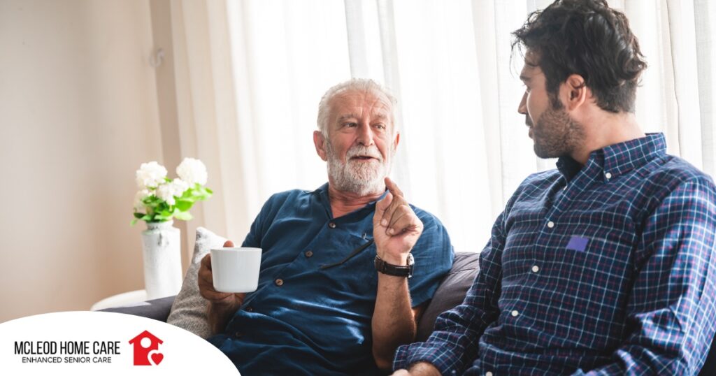 A son talks with an older parent representing the kind of communication needed to tell how aging parents are doing.