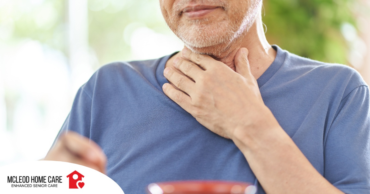 An older adult holds his throat representing dysphagia which can affect senior health.