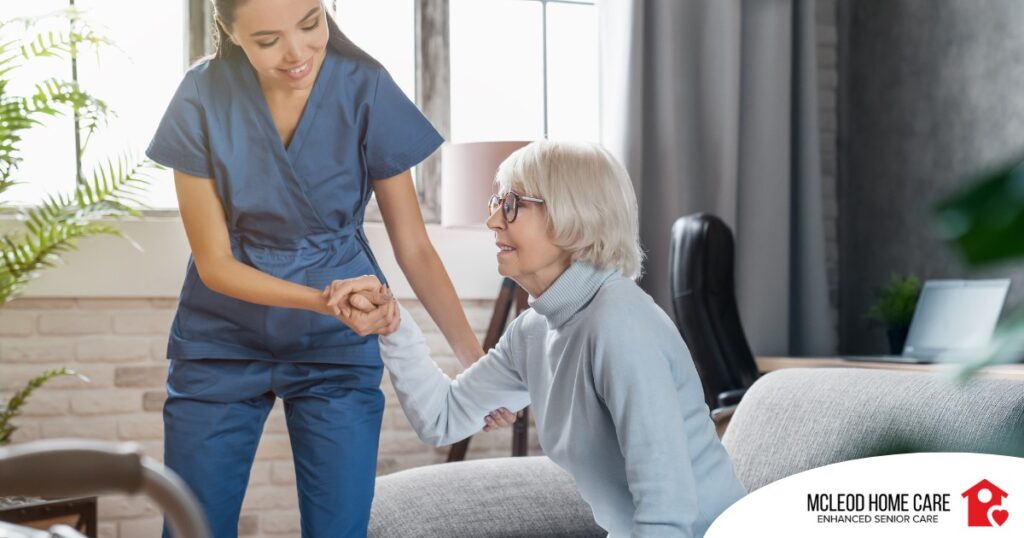 A caregiver demonstrates her caregiver skills by helping an older adult get up.