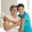 A caregiver hugs an older client, representing how a trustworthy caregiver cares for clients.