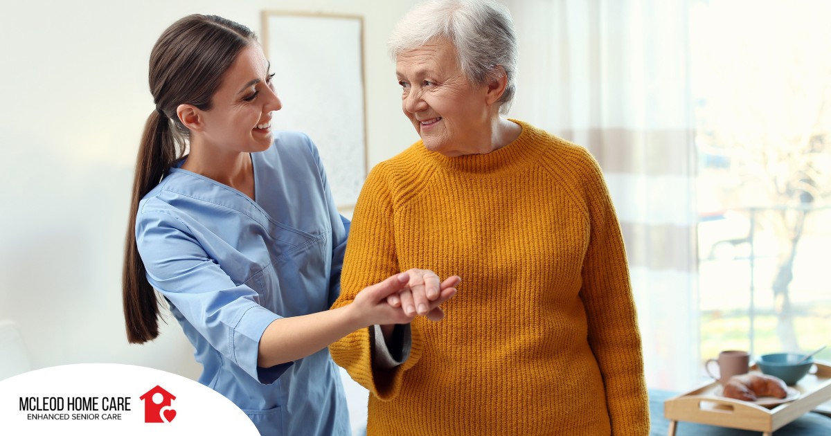 A caregiver helps a client get around, demonstrating one of the job duties of a caregiver.