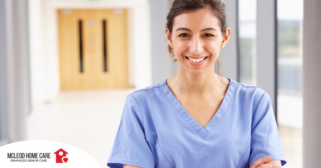 A woman in scrubs smiles, representing the good results that can come when caregivers branch out to become CNAs.