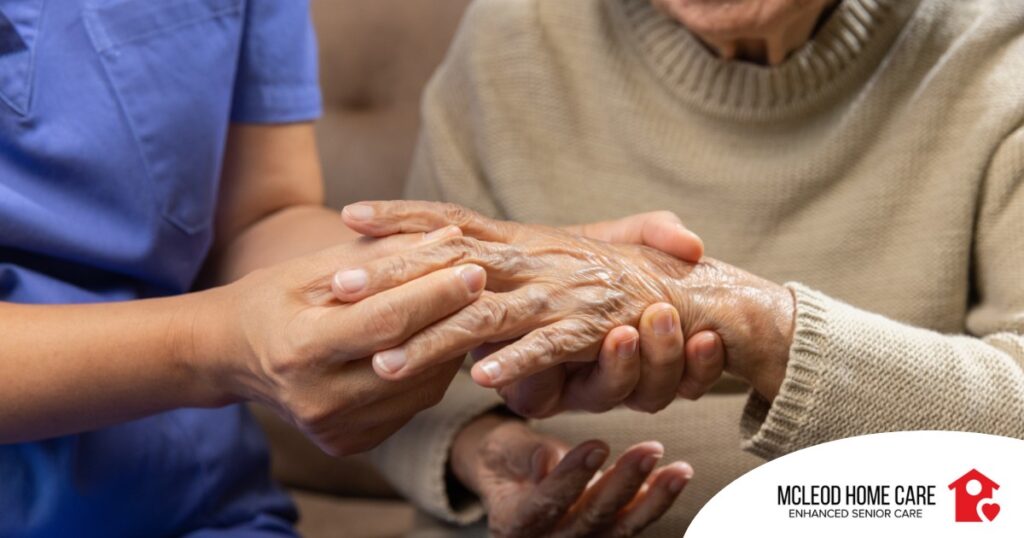 A care provider examines an older adult’s fingers, representing what would happen in an examination for rheumatoid arthritis.