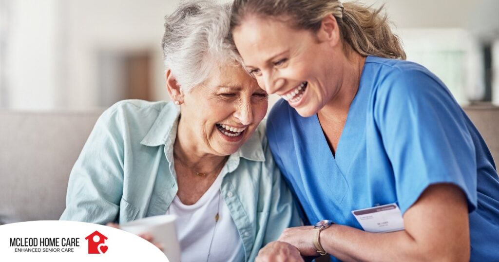 A woman in scrubs laughs with a senior woman, representing how caregiving can be a great career choice.