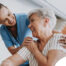A female caregiver helping an older woman with stroke recovery at home.